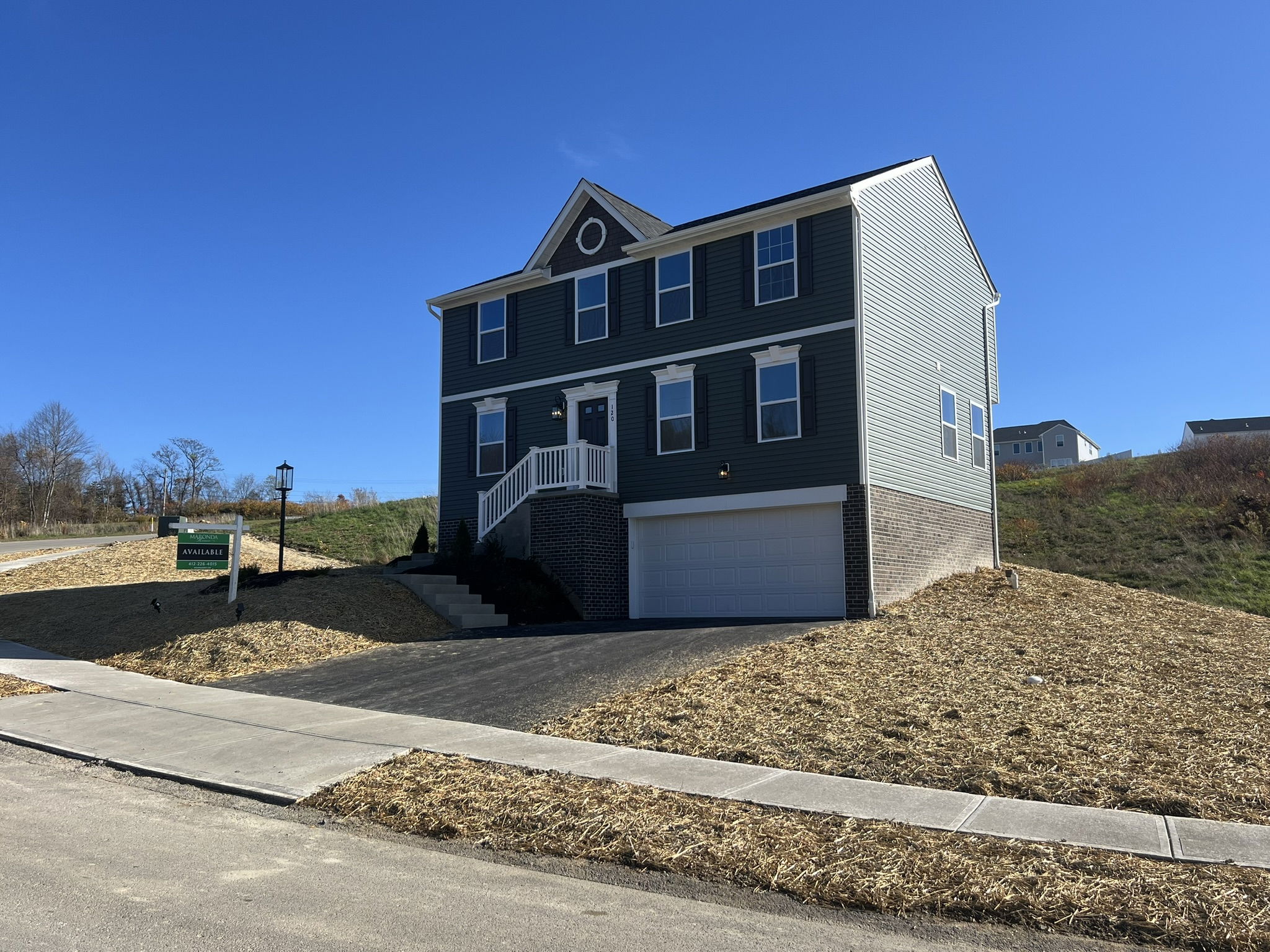 Two-story gray house with a white garage and a 
