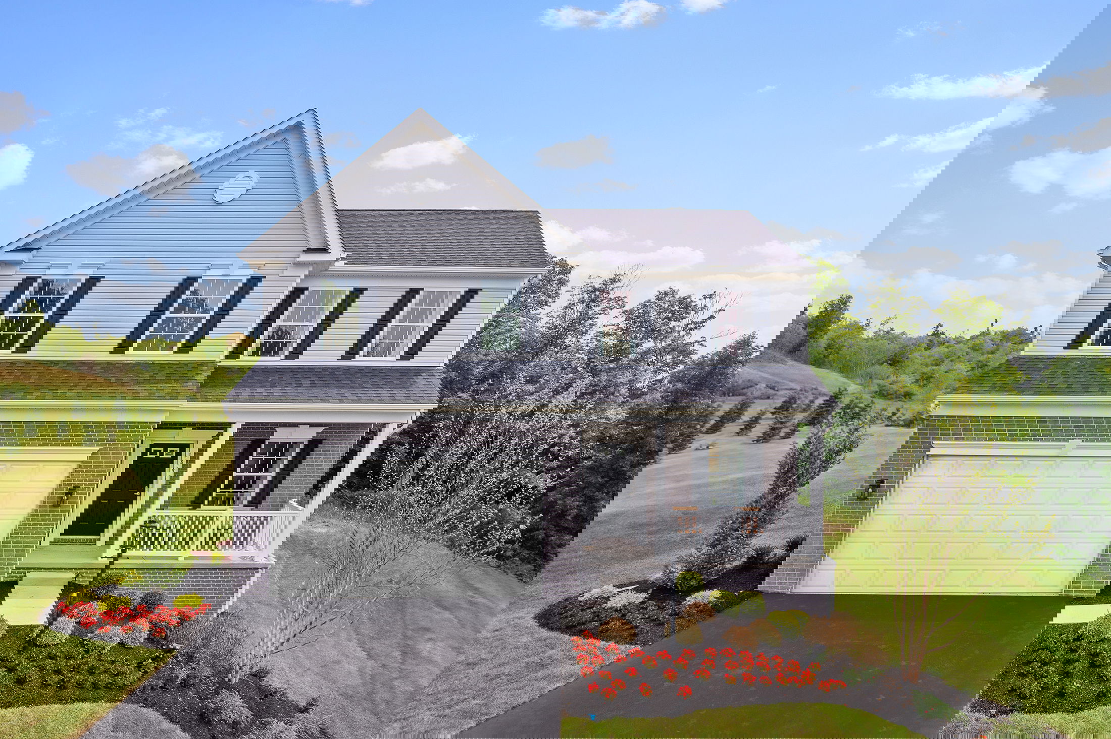 Glitched image of a residential house with a blue sky and greenery, showcasing distorted architectural elements and colors.