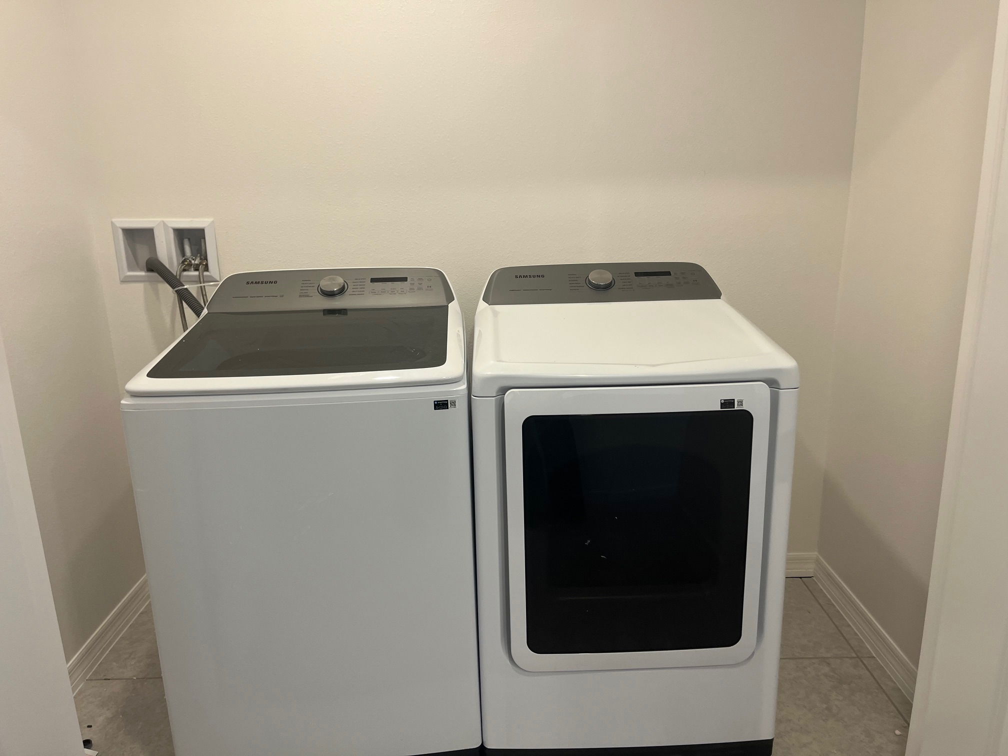Modern Samsung washer and dryer set in a laundry room.