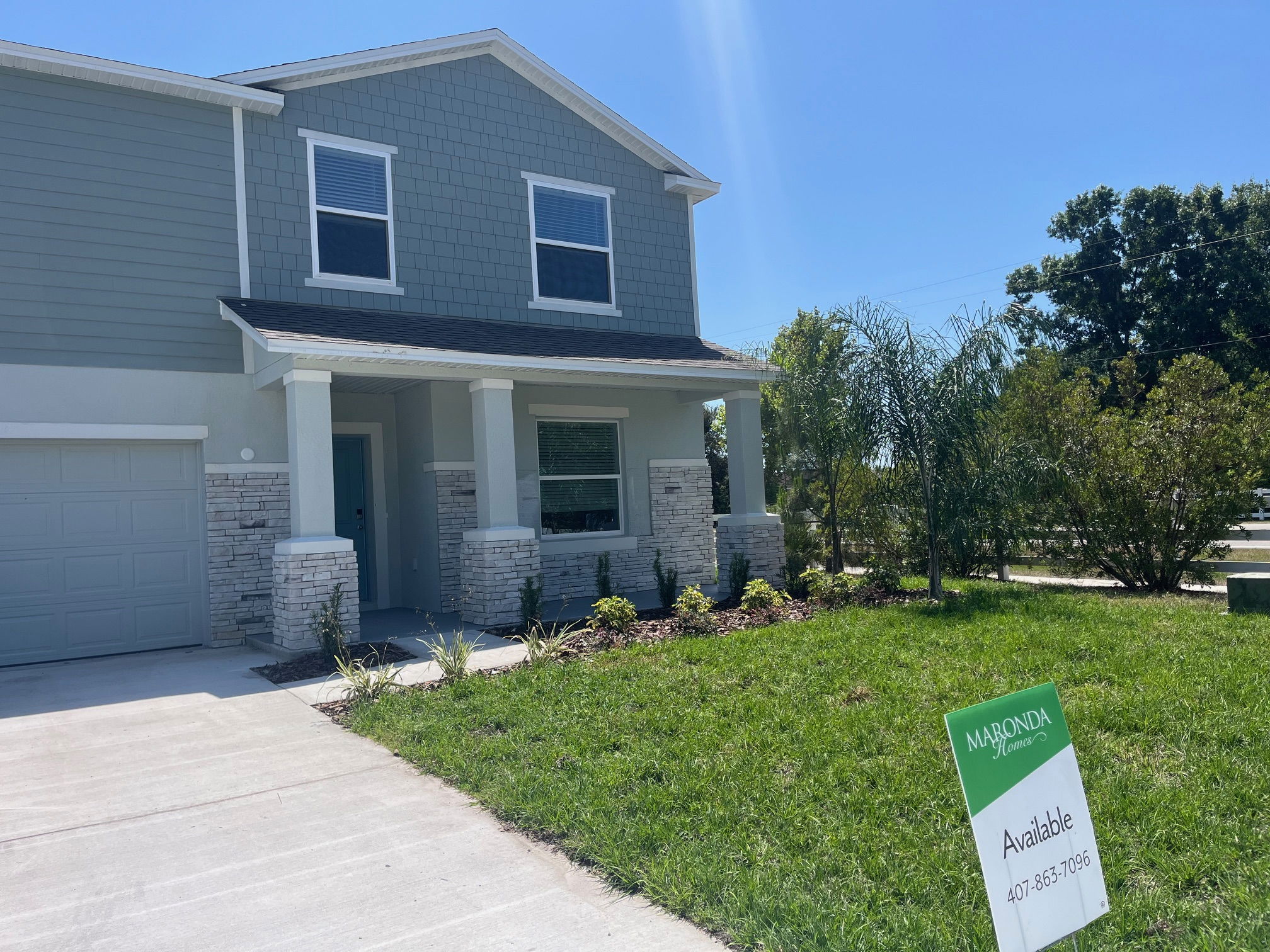 Modern two-story house for sale by Maronda Homes with a lush green lawn and driveway.
