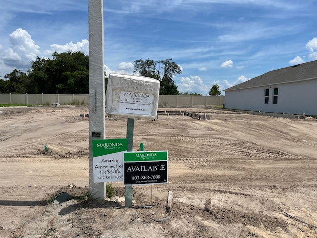 Construction site for a new home with Maronda Homes signage indicating availability and pricing details.