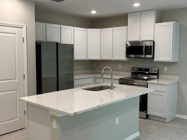 Modern kitchen with white cabinets, stainless steel appliances, and a large island with a sink.