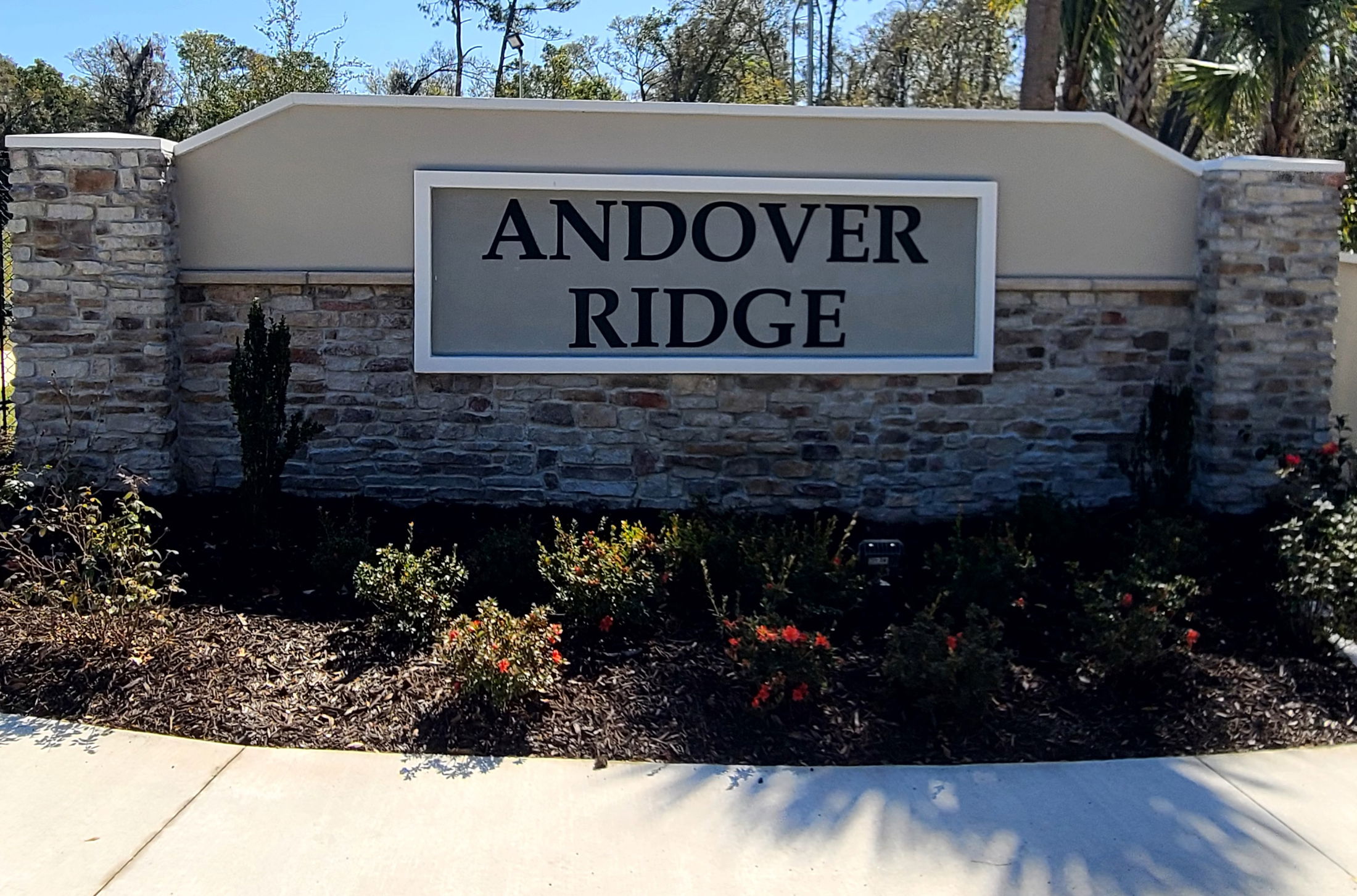 Entrance sign for Andover Ridge neighborhood with stone accents and landscaped surroundings.