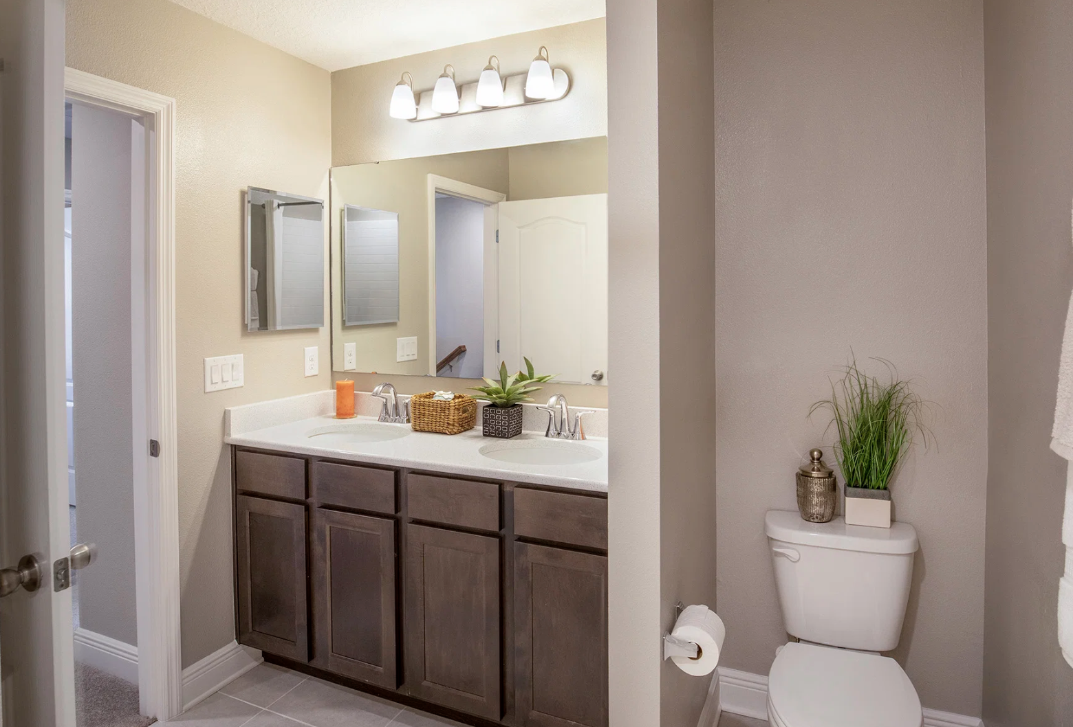 Modern bathroom design featuring dual sinks, stylish lighting, and contemporary decor accents.