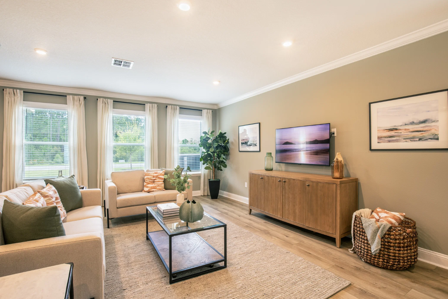 Cozy modern living room with a neutral color palette, stylish furniture, and large windows allowing natural light.