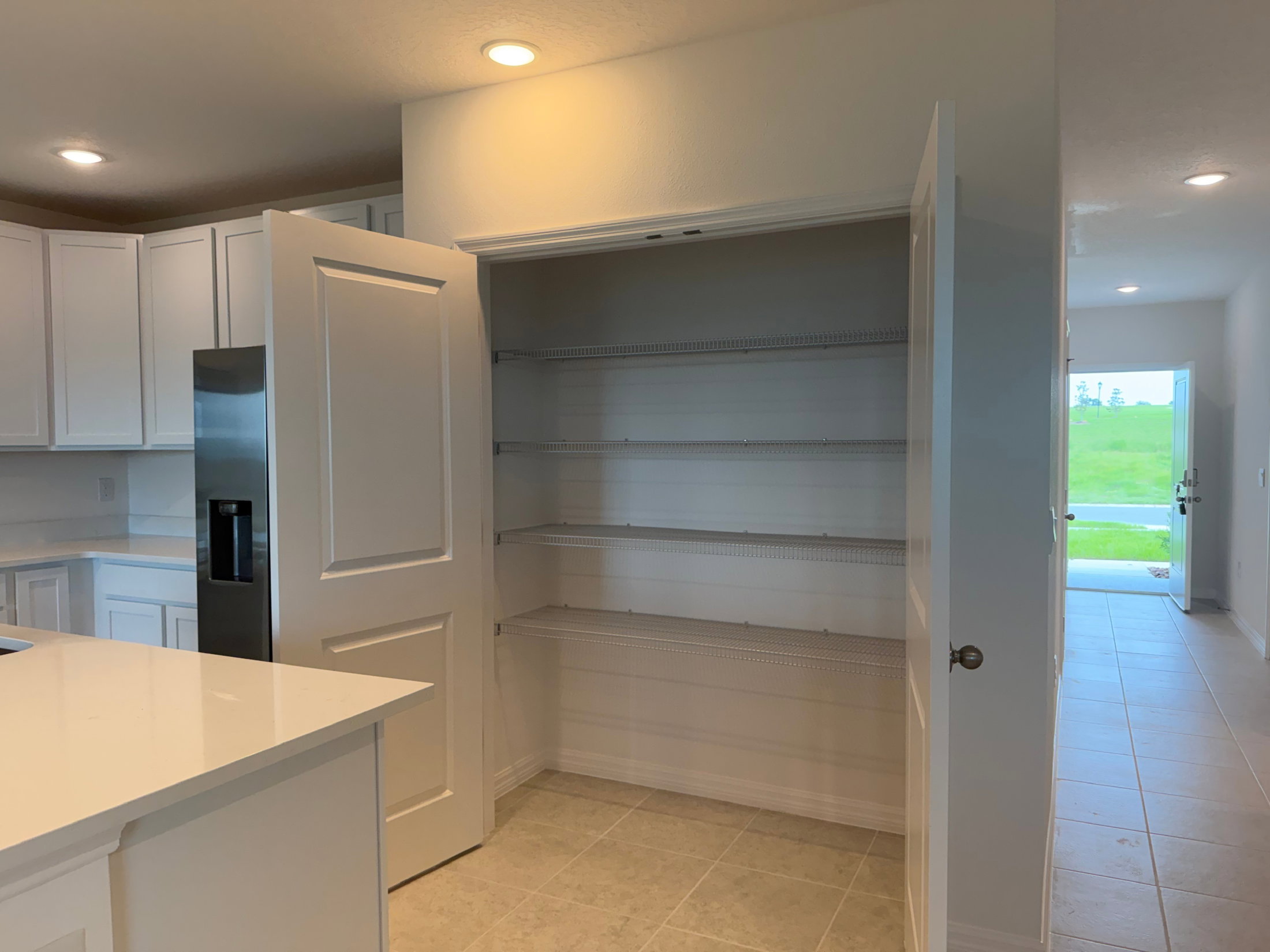 Open pantry with empty shelves in a modern kitchen.