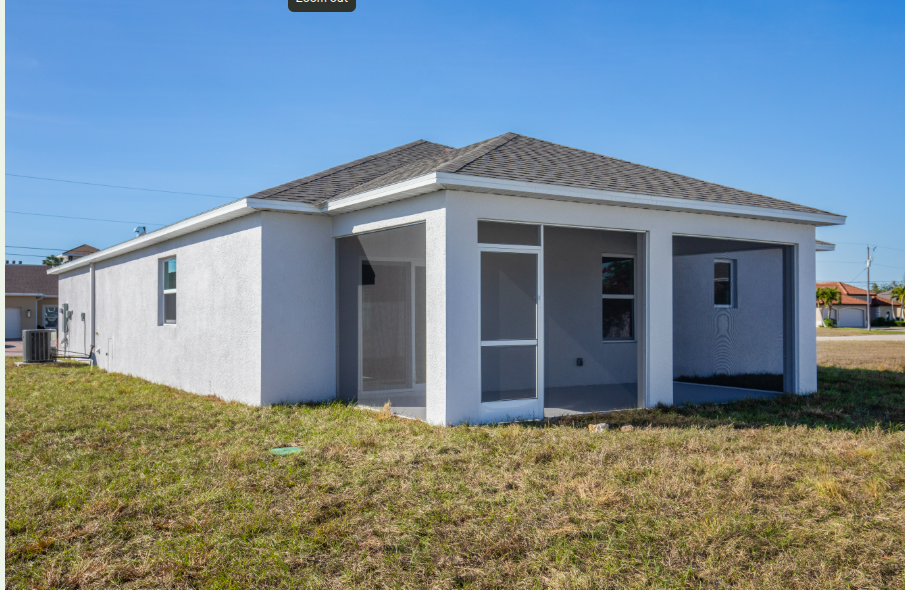 Single-story modern home with a screened porch and spacious lawn under clear blue skies.