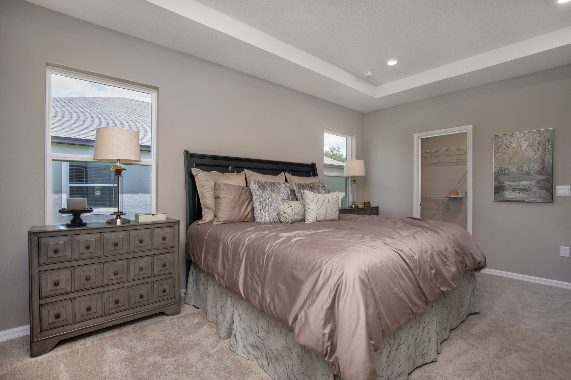 Modern bedroom with a plush queen-sized bed, elegant nightstands, and soft ambient lighting.
