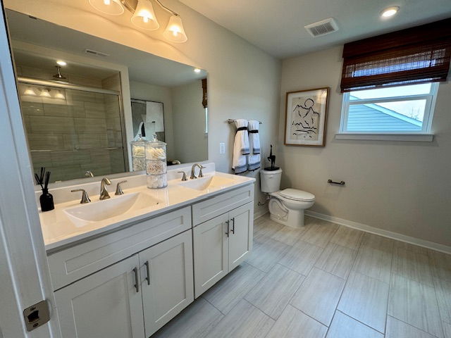 Modern bathroom interior featuring a double-sink vanity, glass-enclosed shower, toilet, and wall art with natural light from a window.