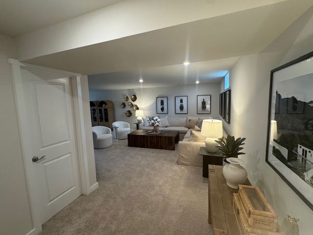Cozy, modern basement living room with sectional sofa, stylish decor, and ambient lighting.