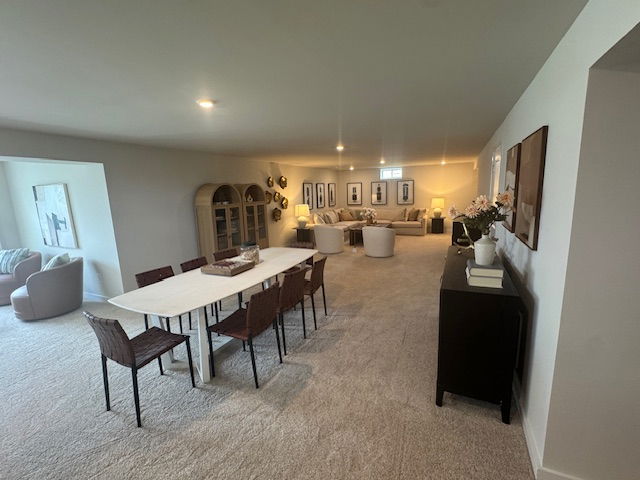 Spacious modern living and dining room with neutral decor, contemporary furniture, and decorative wall art.