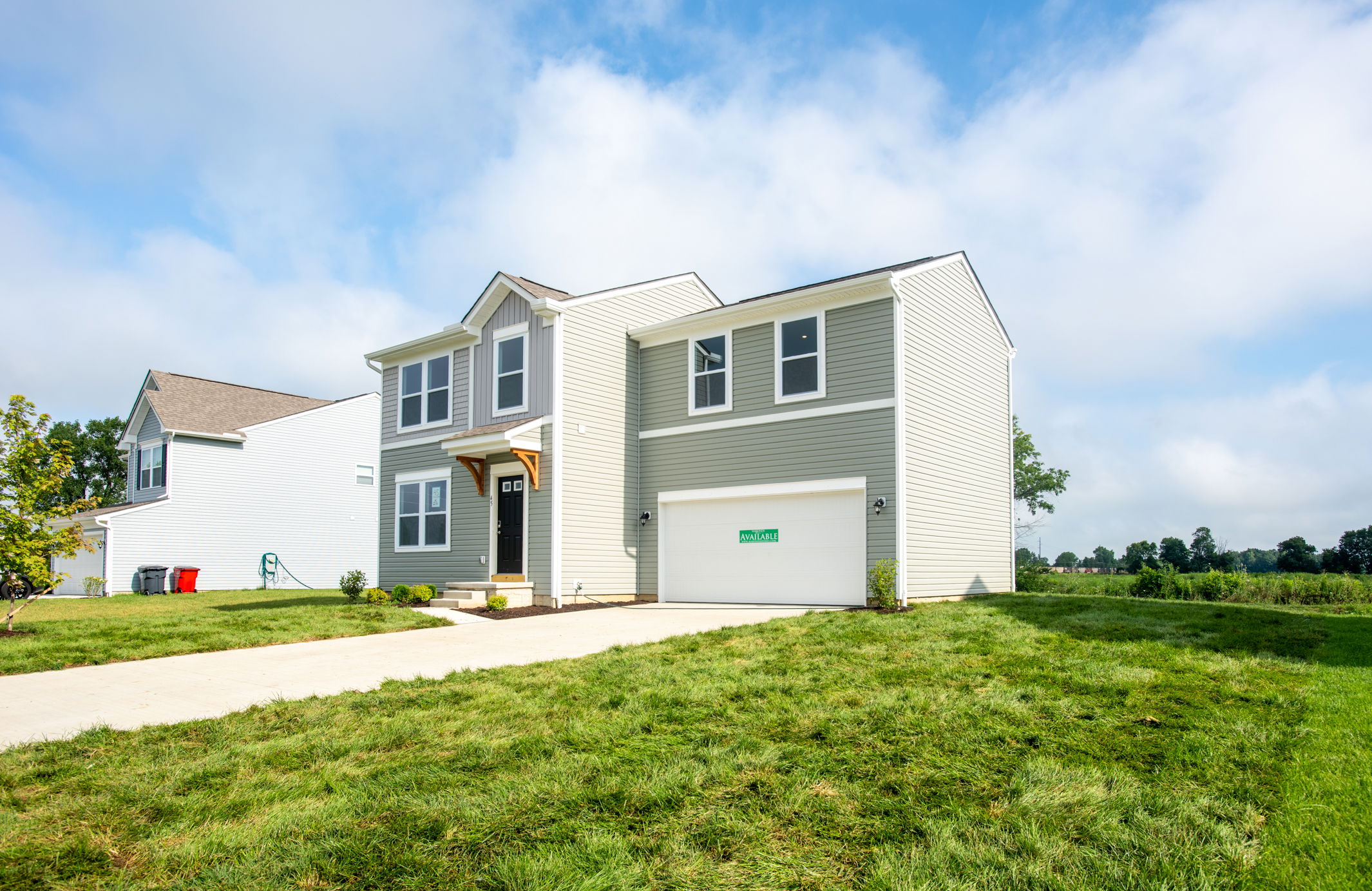 Modern two-story house with a green lawn and 