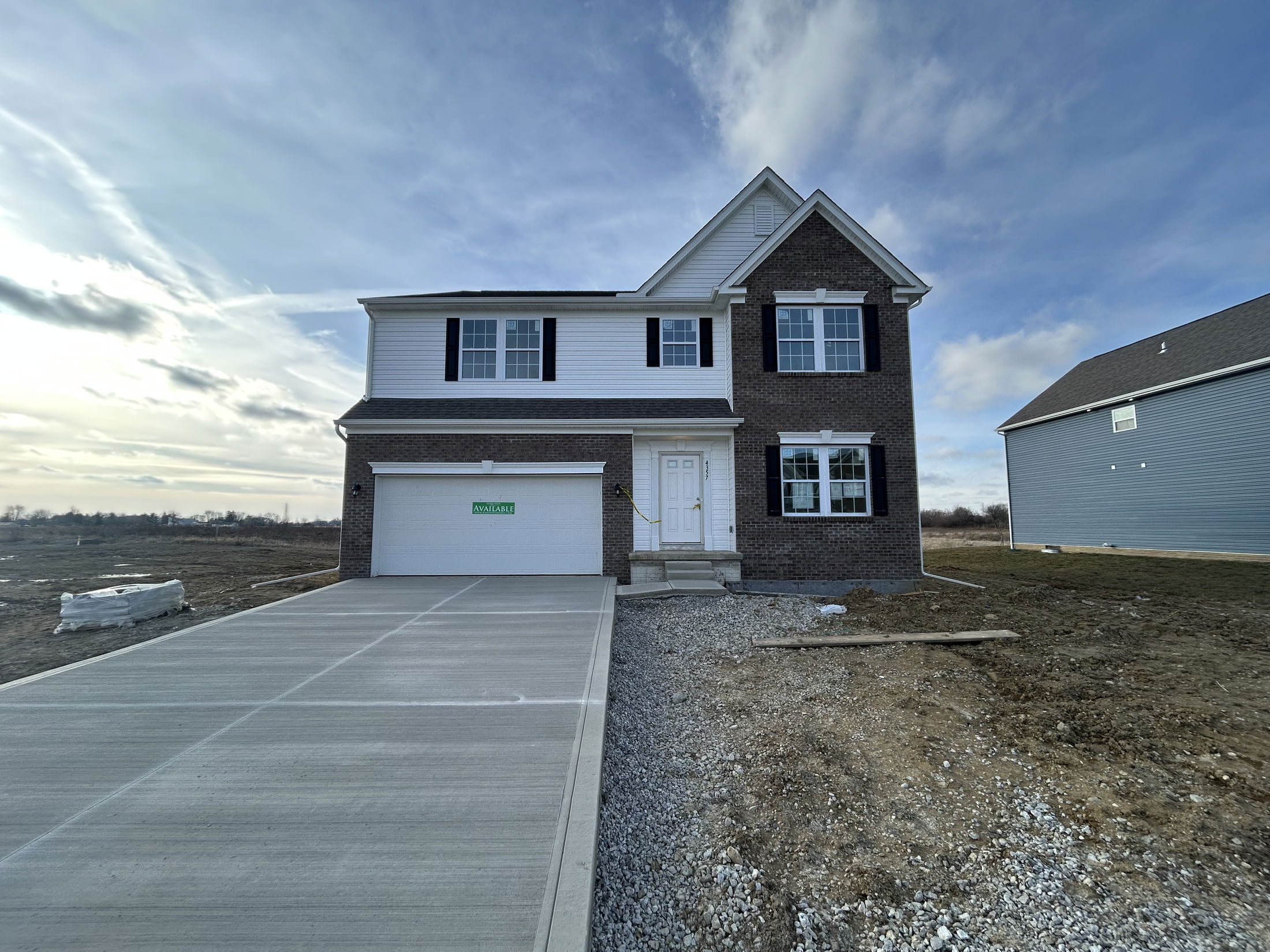 Newly built two-story house with a spacious driveway and 