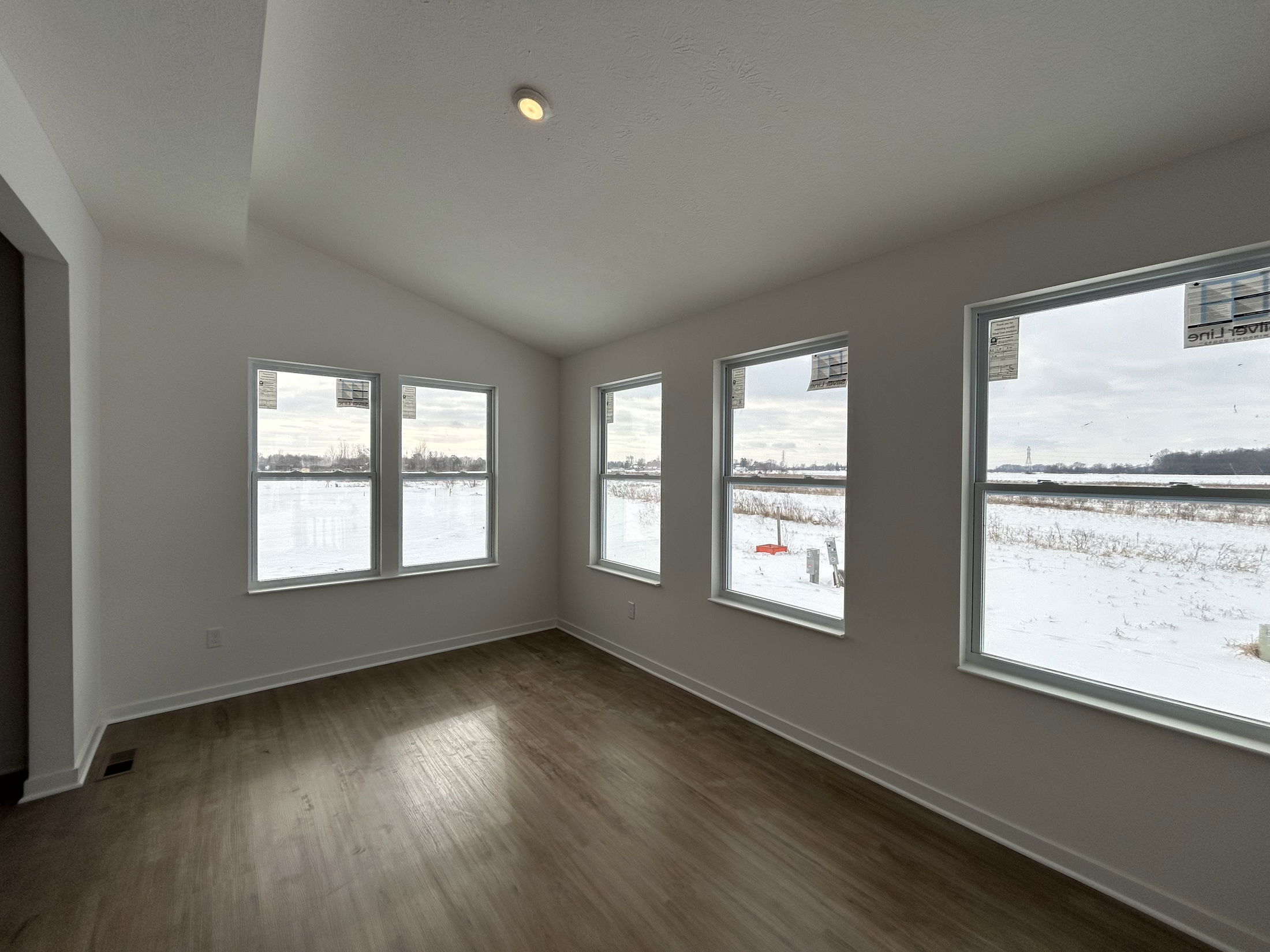 Bright, open living space with large windows overlooking a snowy landscape.